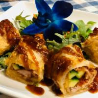 Peking Duck Wrap · Crispy roast duck wrapped in roti with scallions and cucumber topped with Peking sauce.