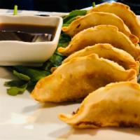 6 pieces Gyoza · Mixed pork and chicken wrapped in soft rice noodle served with a ginger sauce. (dumpling)