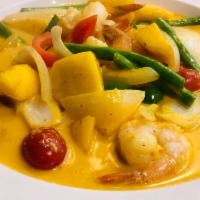 Mango Curry Dish Dinner · Slices of fresh sweet mango, carrots, onions, green peppers and red peppers in yellow curry.