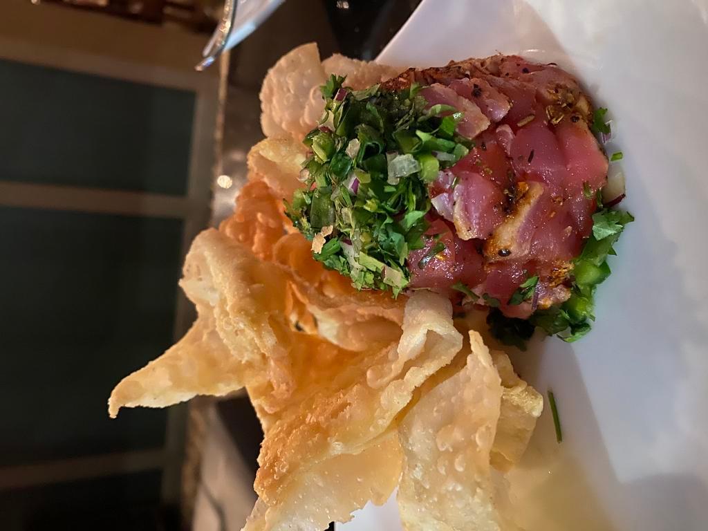 Seared Tuna Tartar · Cubed sushi grade ahi tuna, cilantro, and jalapeno. Served with wontons and a wasabi cream sauce. Make it gluten free upon request.