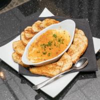 Spinach Artichoke Dip · A creamy blend of spinach, artichokes, Parmesan, and cream cheese. Served with toasted garli...