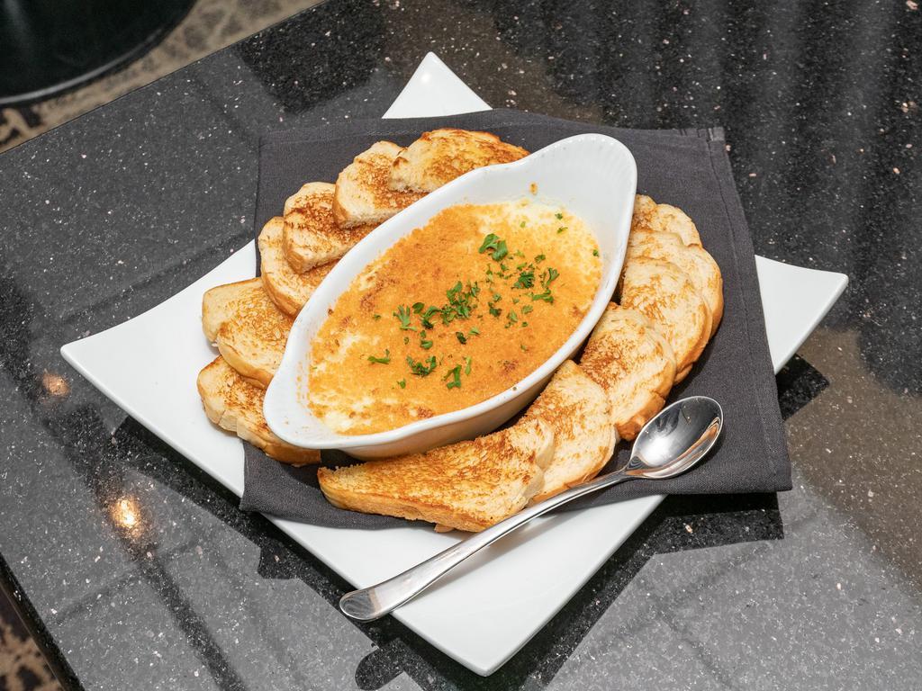 Spinach Artichoke Dip · A creamy blend of spinach, artichokes, Parmesan, and cream cheese. Served with toasted garlic bread. Make it gluten free upon request.