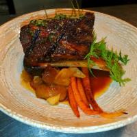 Braised beef short rib · served over baby roasted baby carrots, spicy yogurt smudge, topped with french pesto