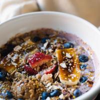 Sweet Breakfast Bowl · Acai yogurt, bruleed banana, granola, berries, peanut butter, roasted nuts, shaved coconut