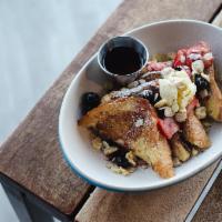 Classic French Toast · Brioche bread, macerated berries, candied almonds, creme fraiche, and maple syrup.