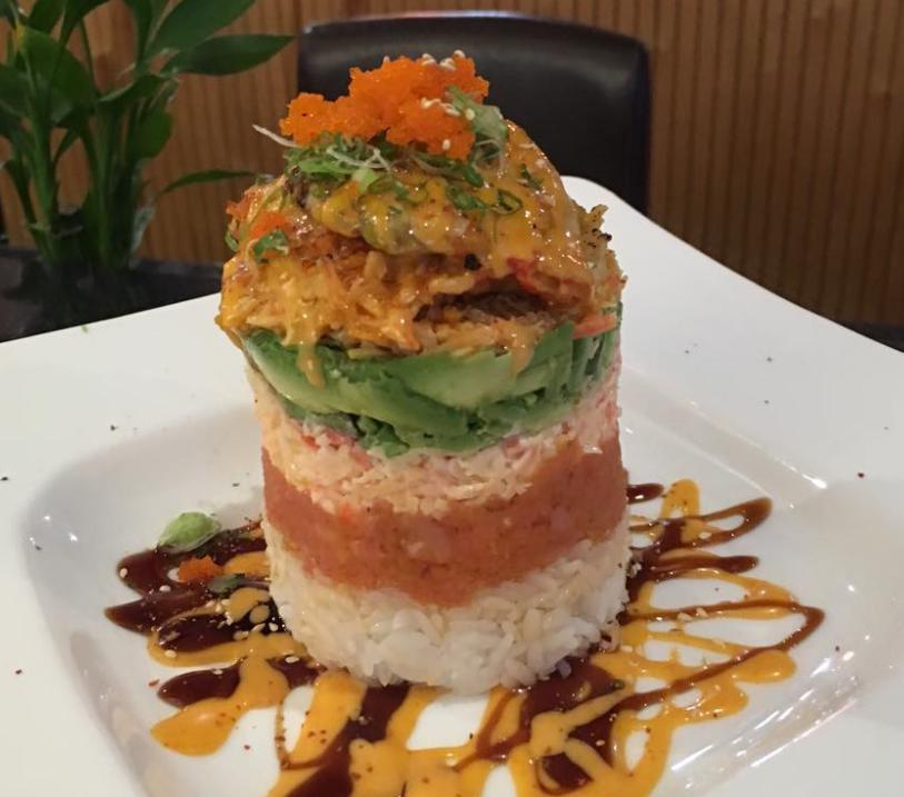 Ahi Tower Roll · Rice, spicy crabmeat, avocado, spicy tuna, snow crab meat, crawfish, scallion, masago, sesame seeds and chef's special sauce. May contain raw or undercooked ingredients.
