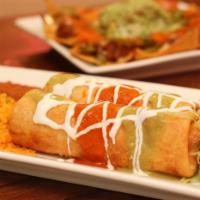 Chimichangas  · Two fried flour tortillas stuffed with shredded choice of protein. Topped with choice of sau...