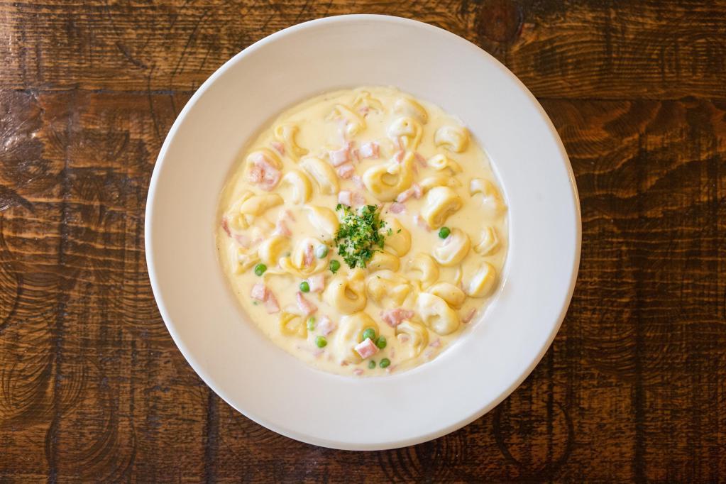 Tortellini · Cheese tortellini with ham and peas served with your choice of sauce. Served with sourdough garlic bread.