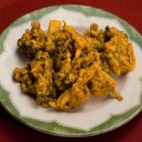 Vegetable Pakora · Vegetable fritters delicately spiced. Served with homemade mint chutney and hot and sour tam...