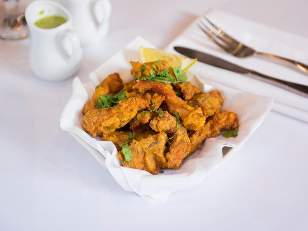 Fish Pakora · Fresh fish marinated with clay oven spices. Served with homemade mint chutney and hot and sour tamarind chutney.