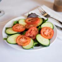 Salad · Fresh organic spring mix salad with cucumber, tomatoes.