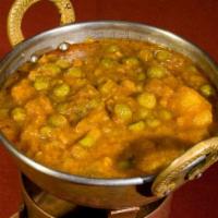 Aloo Mattar · Fresh green peas and potatoes cooked with chopped onions, tomatoes and spices.