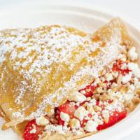Berry Delight Crepe · Strawberries, goat cheese and crushed walnuts drizzled with honey, topped with powdered sugar.