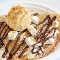 S’mores a la Mode Crepe · Marshmallows and graham cracker crumbs drizzled with nutella and topped with powdered sugar,...