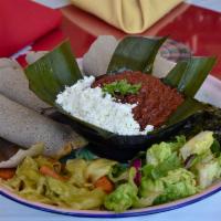 Kitfo · Finely chopped prime beef, mixed with spice butter and mitmita (seasonal hot pepper). Served...