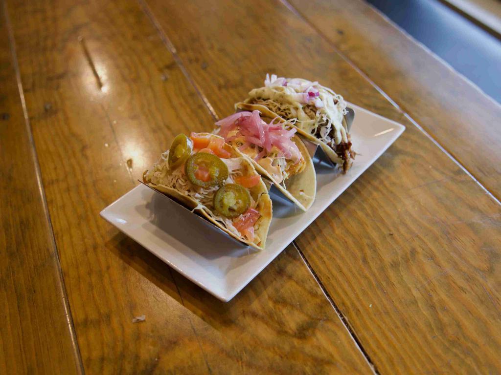 Fish Taco · Fried or Pan-Seared cod, pickled red onion, napa slaw and cilantro lime aioli.