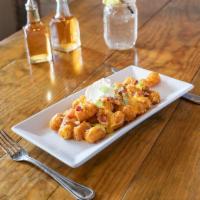 Loaded Tots · Melted Monterey Jack, bacon, scallions and side of sour cream.