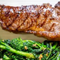 Wood Grilled NY Strip · 16 oz. strip steak, broccoli rabe, and nutmeg sea salt roasted potatoes.