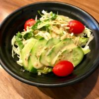 House Salad · Shredded cabbage, cherry tomato and cucumber with sesame dressing.