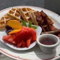 Waffle Shuffle · Crispy waffles, maple syrup, fruit bowl, choice of meat.