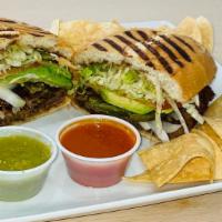 Torta de Milanes · Your Choice of Meat Topped with Pinto Beans, Mayo, Lettuce, Onion, Avocado, and Jalapeno. Me...