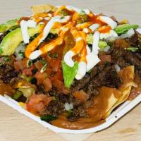 Nacho Loco · Topped with Your Choice of Meat, Shredded Cheese, Tomato, Onion, Sour Cream, & Avocado.