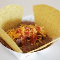 Refried Beans · Refried beans, shredded cheese, taco sauce and chips.