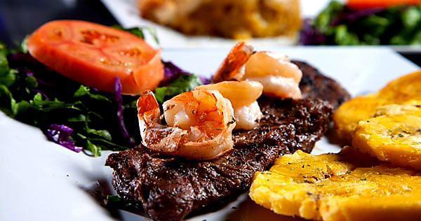 Churrasco con Camarones · Skirt steak with grilled shrimp. Servidos con dos acompanantes у una tortilla: arroz, casamiento, maduros, ensalada served with two sides and one tortilla: rice, mix rice, sweet plantains, salad.