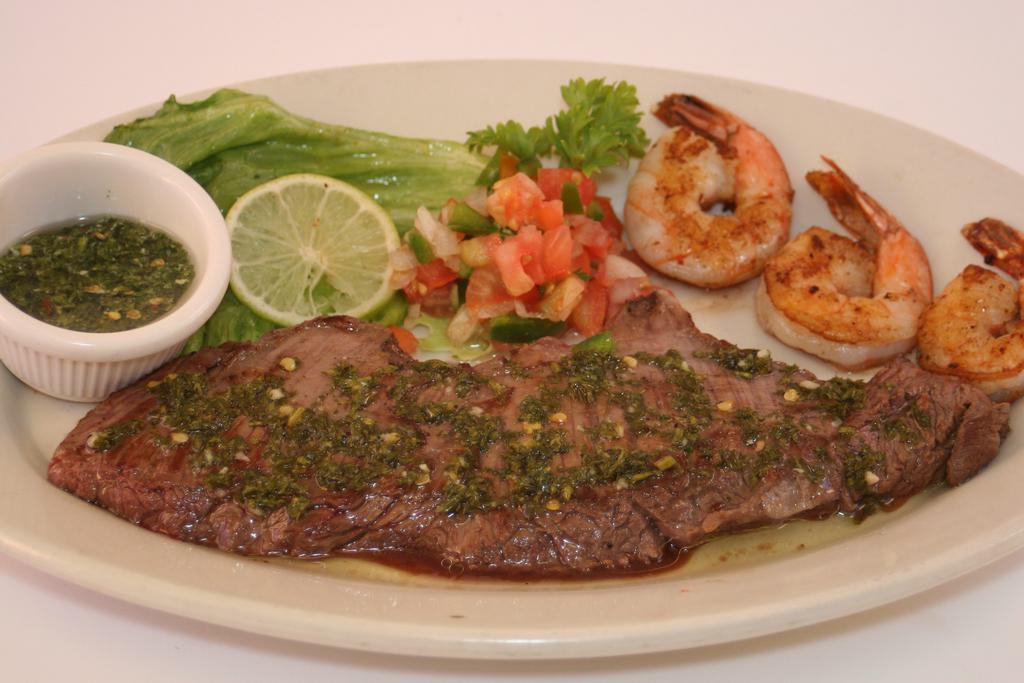 Carne Asada Marimonte · Grilled flap meat with grilled shrimps. Servidos con dos acompanantes у una tortilla: arroz, casamiento, maduros, ensalada served with two sides and one tortilla: rice, mix rice, sweet plantains, salad.