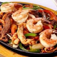 Fajitas Fiesta · Mixed fajitas of beef, chicken and shrimp with onions, green peppers, seared or in sauce. Se...