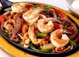 Fajitas Fiesta · Mixed fajitas of beef, chicken and shrimp with onions, green peppers, seared or in sauce. Servidos con dos acompanantes у una tortilla: arroz, casamiento, maduros, ensalada served with two sides and one tortilla: rice, mix rice, sweet plantains, salad.