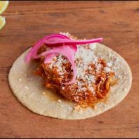 Taco Tinga · Chicken breast slowly simmered in a tomatoe and chipotle sauce. Light cotija cheese and pick...