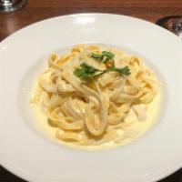 Fettucine Alfredo · Homemade pasta with savory parmesan-cream 