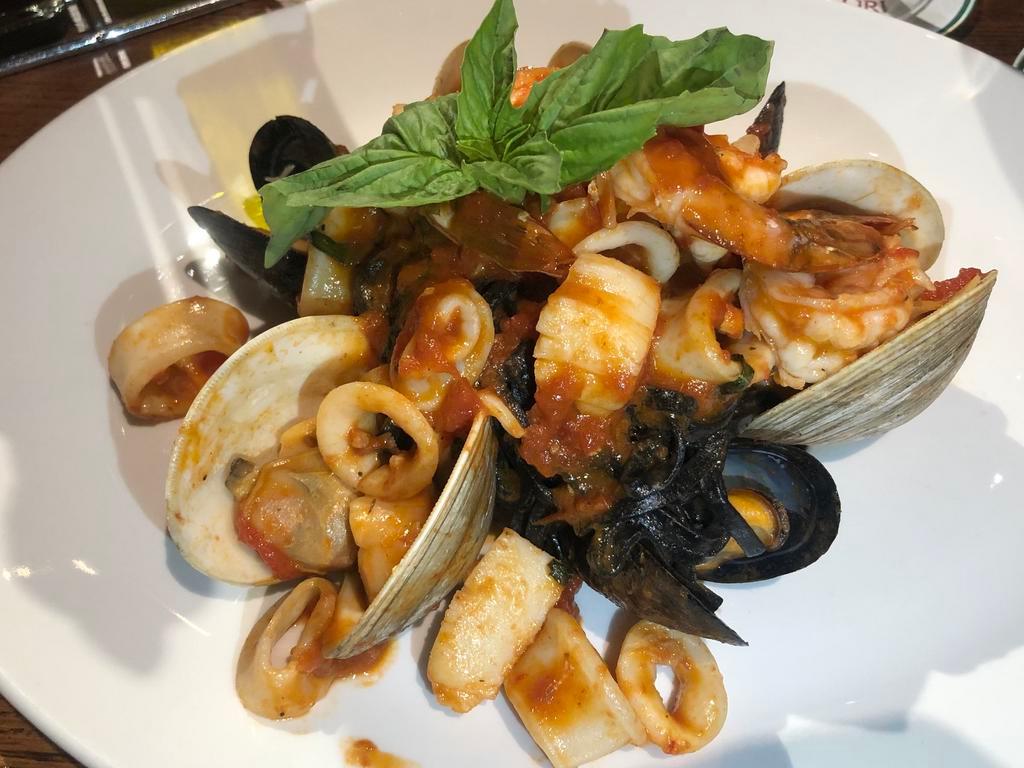 Linguine Monsignore · Squid-ink pasta, little neck clams, mussels, scallops, shrimp & calamari, marinara sauce