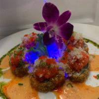 Volcano Roll · Deep-fried white fish avocado cream cheese and jalapeno with spicy tuna top. Hot and spicy.