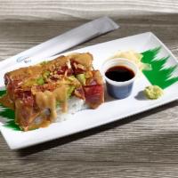 Monster Roll · Salmon, avocado and kani topped with spicy seared tuna, avocado and fried onion.