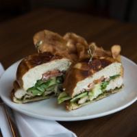 Grilled Pesto Chicken Sandwich · Grilled cage free chicken with house basil pesto, goat cheese, tomato and spring mix, on pre...