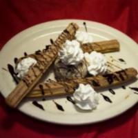 Churros · Cinnamon sticks filled with caramel and topped whipped cream, cinnamon, sugar and chocolate ...