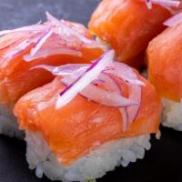 (f049) Philly Salmon Roll · California roll topped with cream cheese, salmon, sliced onion, lemon and capers.
