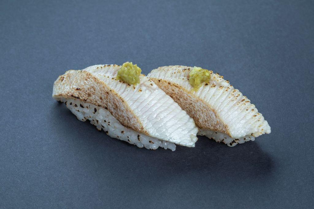 (b018) Aburi Yellowtail Sushi · Two pieces.