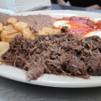 Huevos Rancheros with Barbacoa · 3 eggs with ranchero sauce on top, served with barbacoa, breakfast potatoes, refried beans a...