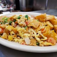 Migas with Eggs · Eggs mixed with tortilla chips and pico de gallo, served with breakfast potatoes, refried be...