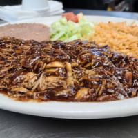 Pollo con Mole · Shredded chicken breast topped with mole sauce, served with rice, refried beans and 2 tortil...