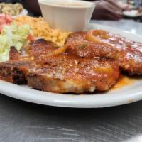 Pork Chop Ranchero · 2 pieces of grilled pork chop topped with ranchero sauce, served with charro beans, rice and...