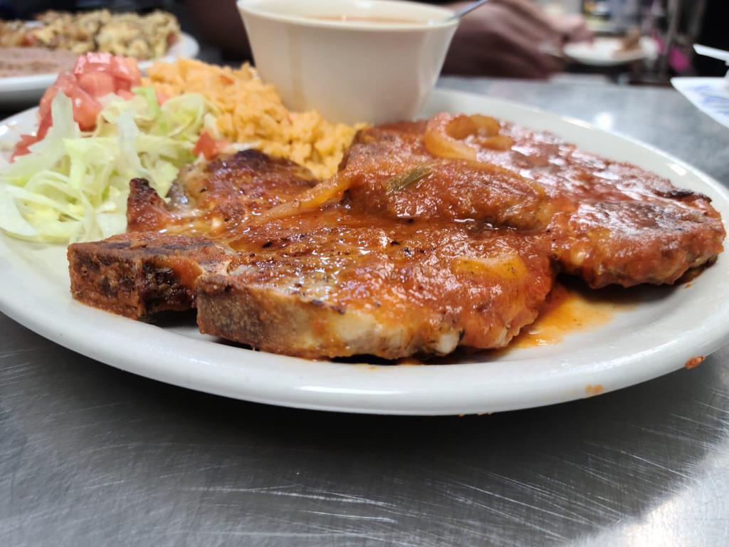Pork Chop Ranchero · 2 pieces of grilled pork chop topped with ranchero sauce, served with charro beans, rice and 2tortillas.