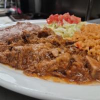 Carne Guisada Plate · Guisada meat, served with rice, refried beans and two tortillas on the side.