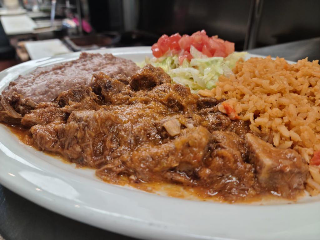 Carne Guisada Plate · Guisada meat, served with rice, refried beans and two tortillas on the side.