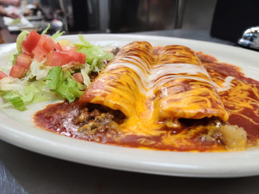 Beef Enchilada Plate · 3 beef enchiladas topped with tex mex sauce melted with cheddar cheese. Served with rice, refried beans and 2 tortillas on the side