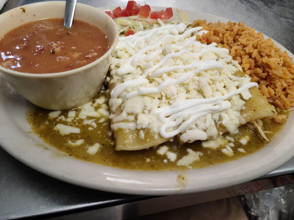 Chicken Enchilada Plate · 3 chicken enchiladas topped with tex mex sauce melted with cheddar cheese. Served with rice, refried beans and 2 tortillas on the side