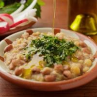 Foul M'damas · Chickpeas, fava beans, garlic, lemon juice, extra virgin olive oil - served with onion, cucu...